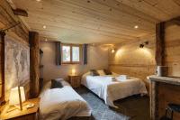 a bedroom with two beds in a log cabin at Chalet Mollard - Happy Rentals in Vallorcine