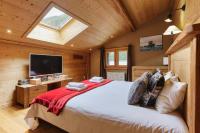a bedroom with a bed and a television in a cabin at Chalet Mollard - Happy Rentals in Vallorcine