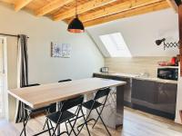 a kitchen with a large wooden table and chairs at Le Patio de Loiseau in Le Mans