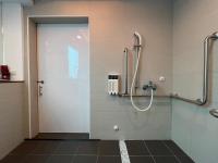 a bathroom with a shower with a glass door at Yomi Hotel - ShuangLian MRT in Taipei