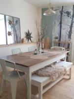 a dining room table with two chairs and a table with at Bel appartement, 2 chambres, centre ville in Thiers