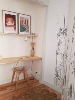 a room with a desk with a chair and paintings at Bel appartement, 2 chambres, centre ville in Thiers