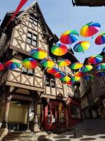 a bunch of colorful umbrellas hanging from a building at Bel appartement, 2 chambres, centre ville in Thiers