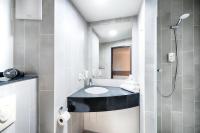 a bathroom with a sink and a shower at B&B HOTEL München-Airport in Hallbergmoos