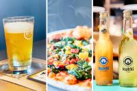 a table with a pizza and a glass of beer at B&B HOTEL München-Airport in Hallbergmoos