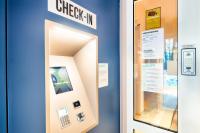 an elevator door with a check in sign on it at B&B HOTEL München-Airport in Hallbergmoos