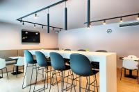 a conference room with a long table and chairs at B&B HOTEL München-Airport in Hallbergmoos