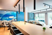 a dining room with a large table and chairs at B&B HOTEL München-Airport in Hallbergmoos