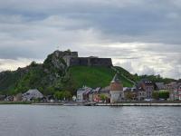 a castle on top of a hill next to a body of water at Le Bellevue in Givet