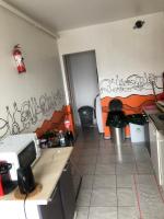 a small kitchen with graffiti on the wall at A 20 minutes de Paris in Sarcelles