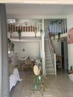 a living room with a staircase and a table at Maison Bouchou in Eyguières