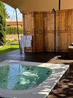 a hot tub in a backyard with a table and chairs at Hotel Rural Xereca in Puig D’en Valls