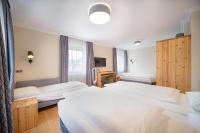 A bed or beds in a room at Das Grüne Hotel zur Post - 100 % BIO