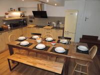 a kitchen with a wooden table with plates on it at Gîte d&#39;AURE. Classé en meublé 4 étoiles. 