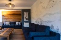 a living room with two blue couches and a table at Gîte d&#39;AURE. Classé en meublé 4 étoiles. 
