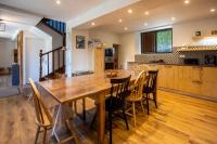 a kitchen and dining room with a wooden table and chairs at Gîte d&#39;AURE. Classé en meublé 4 étoiles. 