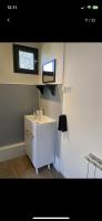 a small bathroom with a sink and a window at Petite maison chaleureuse des boucles de la Seine in Le Mesnil-sous-Jumièges