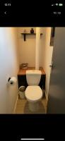 a bathroom with a toilet and a roll of toilet paper at Petite maison chaleureuse des boucles de la Seine in Le Mesnil-sous-Jumièges