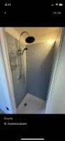 a shower stall in a bathroom with a shower at Petite maison chaleureuse des boucles de la Seine in Le Mesnil-sous-Jumièges