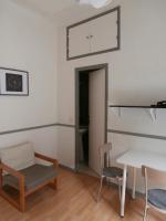 a room with a table and chairs and a mirror at Studio Climatisé dans villa bourgeoise in Nice