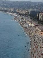 a beach with a lot of people and the water at Studio Climatisé dans villa bourgeoise in Nice