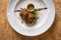 a white plate with food on a table at Imani Country House in Évora