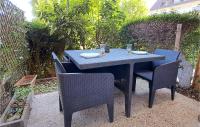 a table with two chairs and a blue table and chairs at Lovely Apartment In Houlgate With Wifi in Houlgate