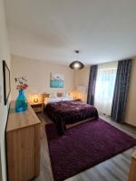 Posteľ alebo postele v izbe v ubytovaní BástyaVár Családi Apartmanház - Gyula