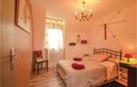 a bedroom with a bed and a chandelier at Stunning Home In Terrasspn-lavilledieu With 3 Bedrooms, Wifi And Outdoor Swimming Pool in Bouillac