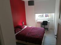 a red bedroom with a bed and a desk at Appartement meublé proche du centre - Wifi&#47;Parking in Clermont-Ferrand