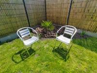 two chairs sitting in the grass in a yard at C La Belle Vie in Pessac