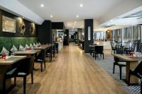 Un restaurante con mesas y sillas y un bar. en Four Points by Sheraton Dar es Salaam New Africa, en Dar es Salaam