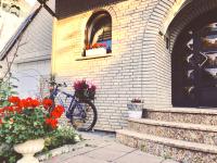 a bike parked on the side of a building with flowers at VILLA ORCHARD Frankfurt in Zeilsheim
