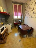 a kitchen with a table and chairs in a room at Chez dada in Grenoble