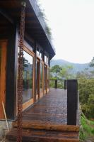 a wooden porch of a building with glass windows at Eco Lodge de Construção Natural com Vista Panorâmica in Nova Friburgo