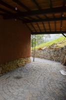 a building with a stone wall and a stone walkway at Eco Lodge de Construção Natural com Vista Panorâmica in Nova Friburgo