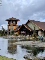 a large building with a clock tower next to a pond at Juniper Ridge Chalet at Eagle Crest Resort in Redmond