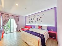 a bedroom with a bed with purple walls at Ocean Star B&amp;B in Kenting