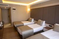 Postel nebo postele na pokoji v ubytování Martinenz Hotel