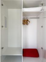 a room with white walls and a red bed at George Studios in Naxos Chora