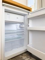 a white refrigerator with its door open at George Studios in Naxos Chora