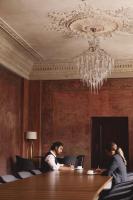 two women sitting at a table in a room with a chandelier at The Wellem, in The Unbound Collection by Hyatt in Düsseldorf