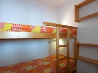 two bunk beds in a small room with a bed at Appartement Méribel, 3 pièces, 6 personnes - FR-1-355-48 in Méribel