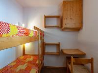 a room with two bunk beds and a table at Appartement Méribel, 3 pièces, 6 personnes - FR-1-355-48 in Méribel