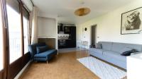 a living room with a blue couch and a chair at Best place à 15 min de Paris in Saint-Maur-des-Fossés