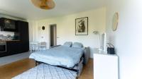 a bedroom with a bed and a table in it at Best place à 15 min de Paris in Saint-Maur-des-Fossés