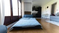 a bedroom with a bed and a blue chair at Best place à 15 min de Paris in Saint-Maur-des-Fossés