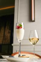 two wine glasses with a dessert in them on a table at The Municipal Hotel Liverpool - MGallery in Liverpool