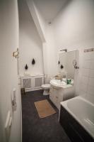 a white bathroom with a sink and a toilet at MAISON RENARD in Béthune
