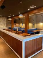 a restaurant with a bar with wooden tables and chairs at Hotel Las Palmas Inn in Punto Fijo